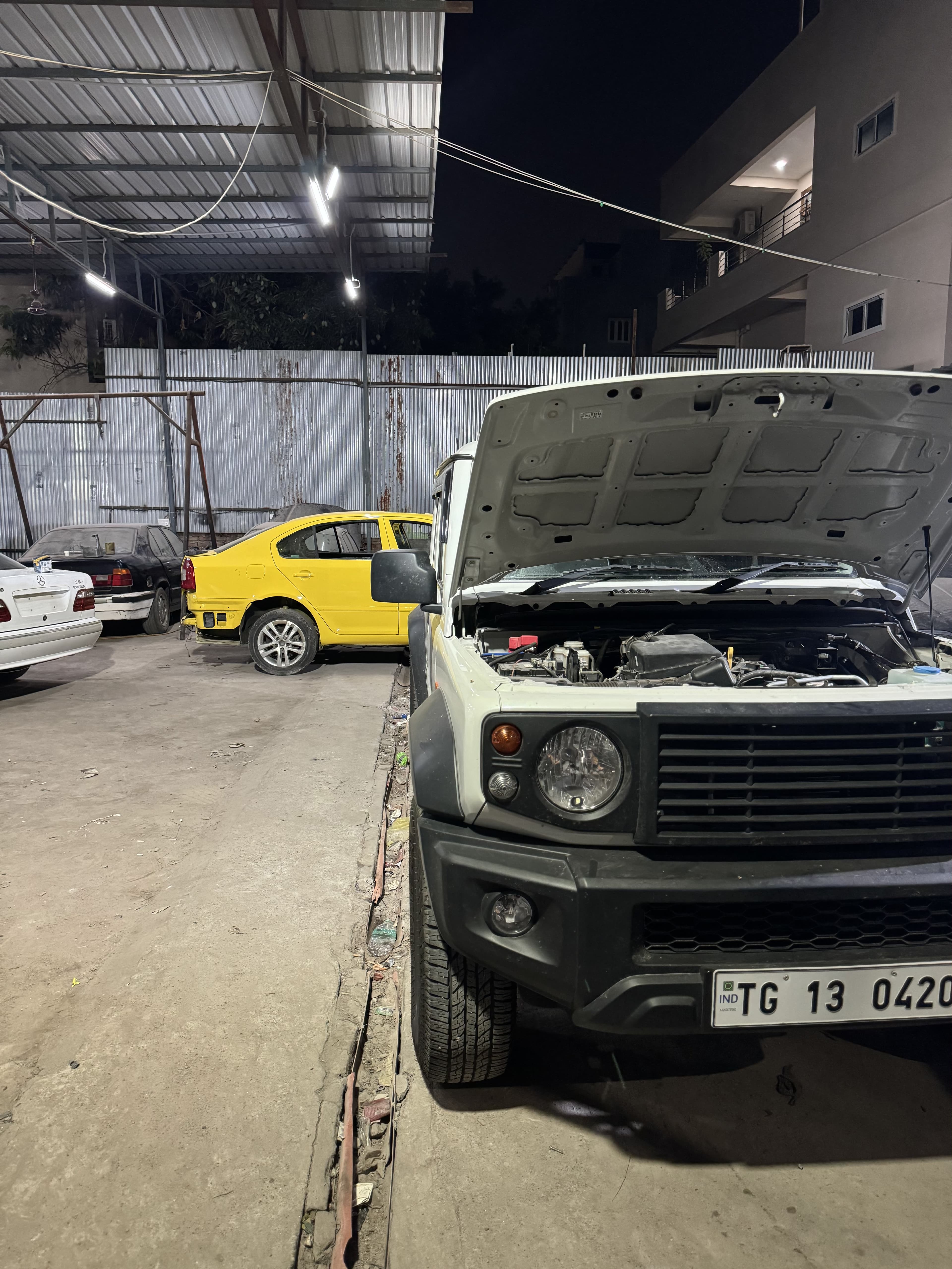 Suzuki Jimny with the engine bay open in the Quick Shift workshop